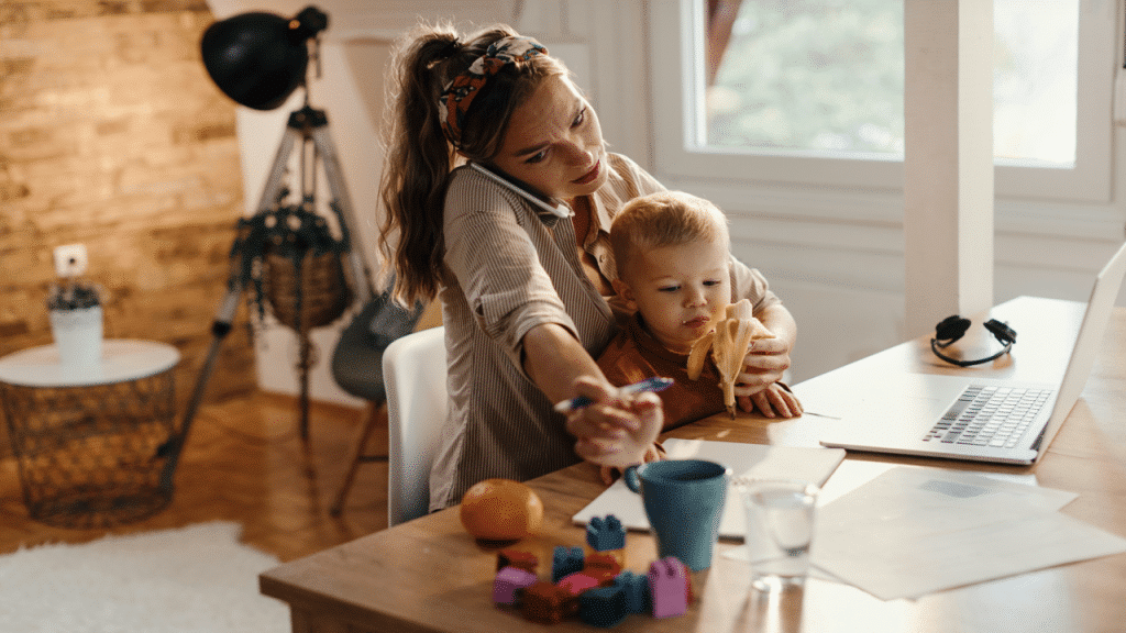 A mom working while taking care of her baby