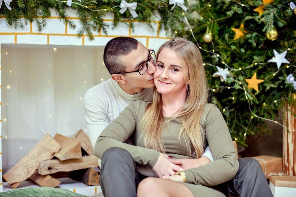 A man kissing a woman’s cheek