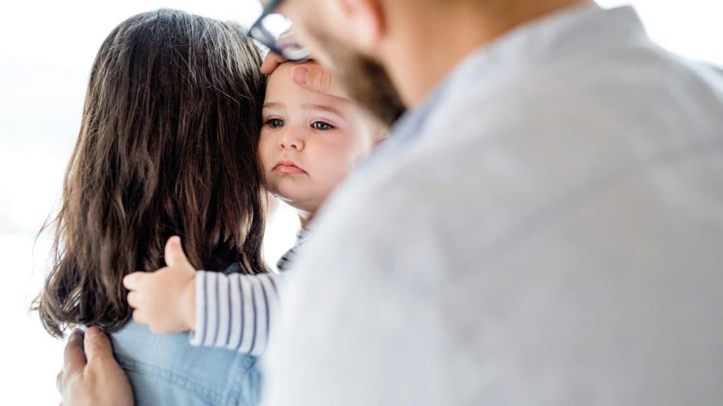 A baby being catered to by the parents.