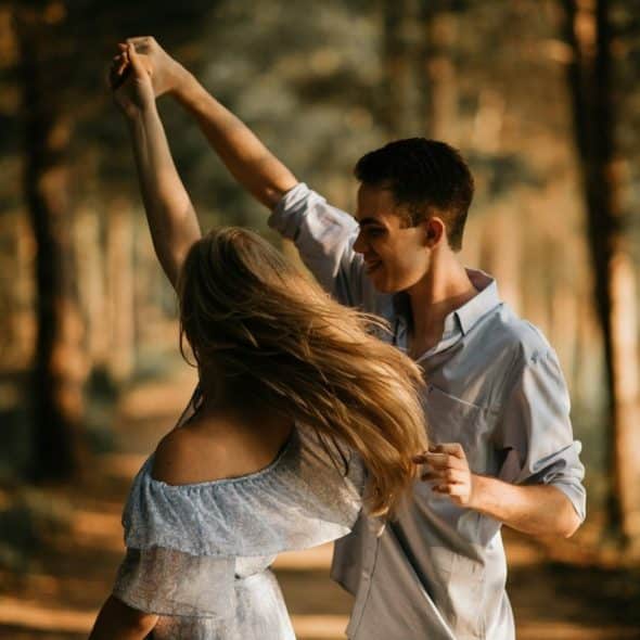 A couple dancing together outdoors.
