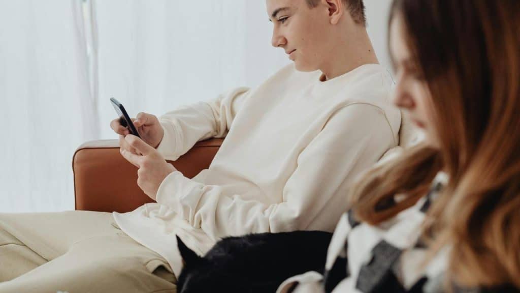 A man and woman with cellphones