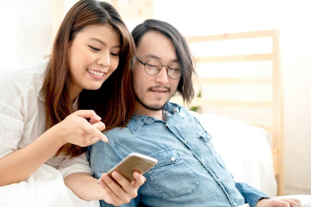 A woman showing something to man