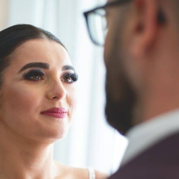 A bride looks at the groom during the wedding ceremony.