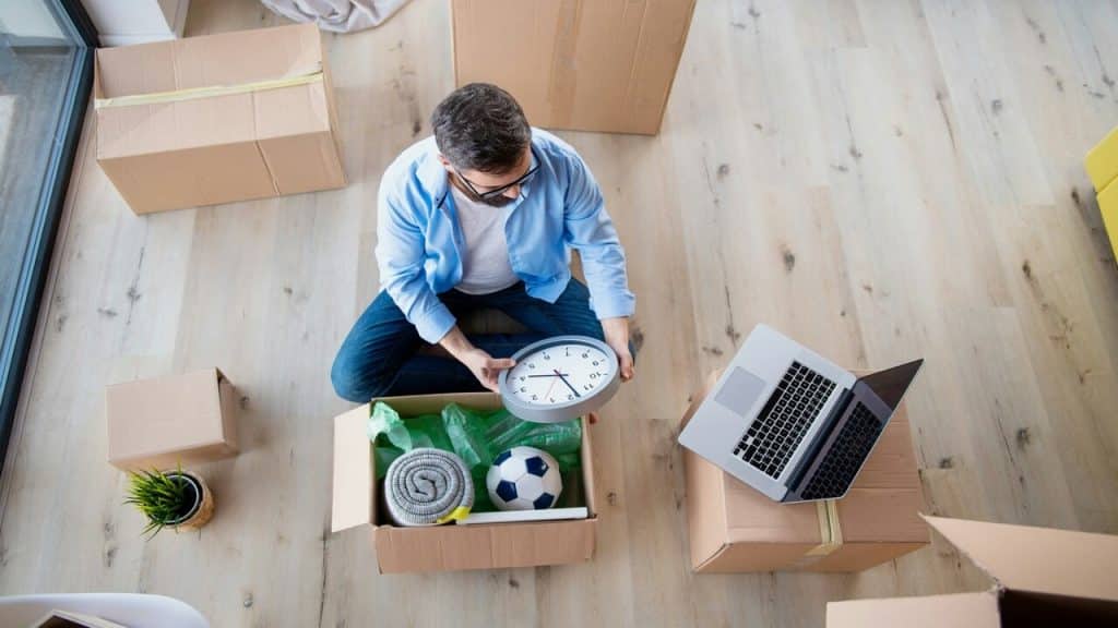 A man unpacking by himself