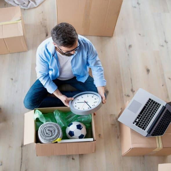 A man unpacking by himself