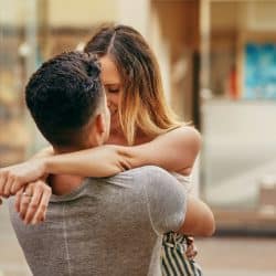 A man and woman hugging each other
