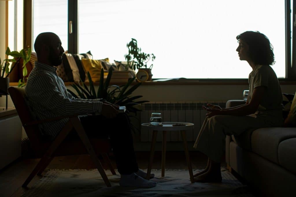 A man and woman facing each other