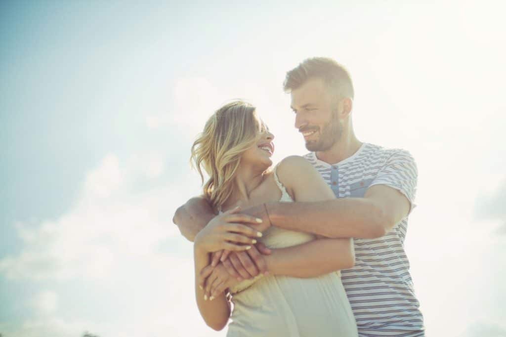 A man hugging a woman