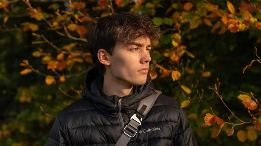 A man looking unsure and has one eye closed. 