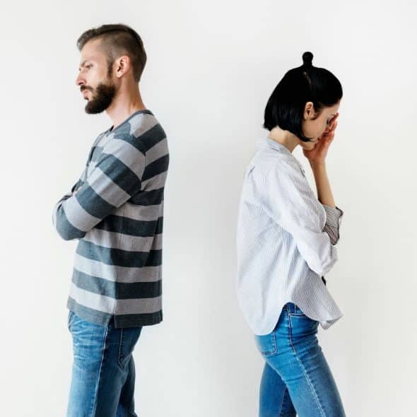 A man and woman facing away from each other