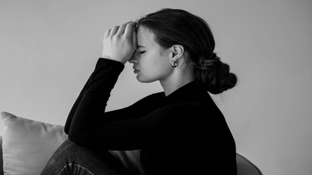 A woman looking sad at home