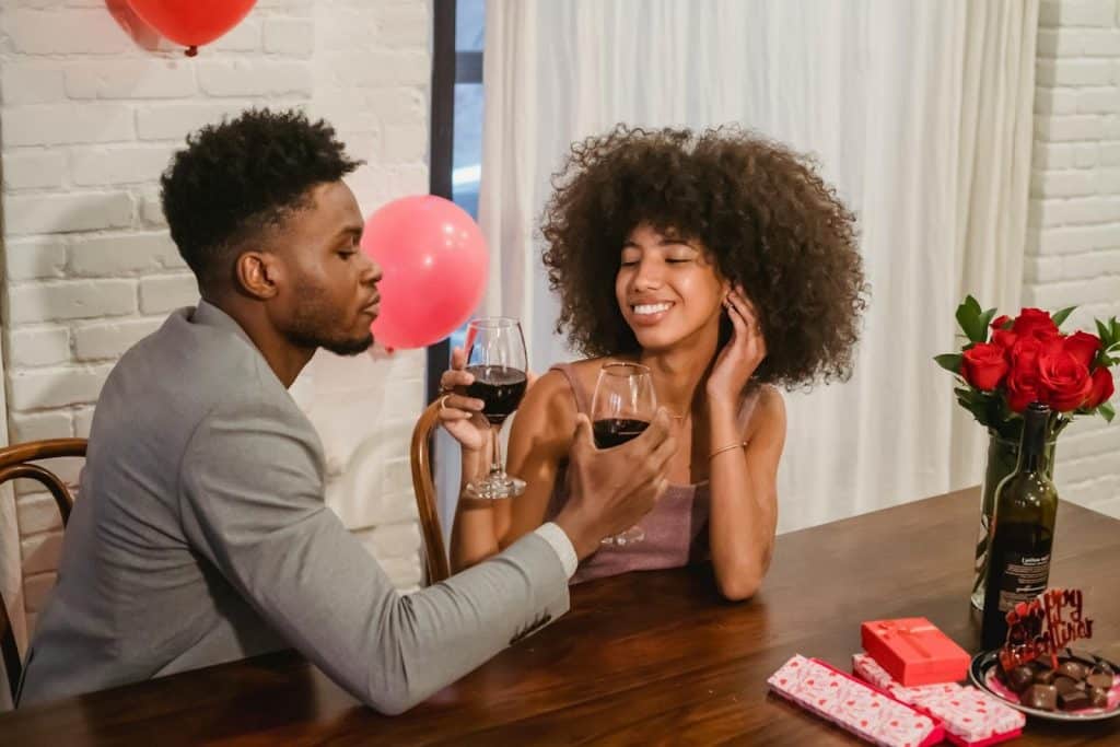 couple drinking wine at wooden table