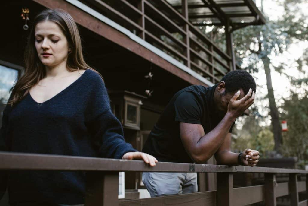 The man is crying as the woman walks away from him.