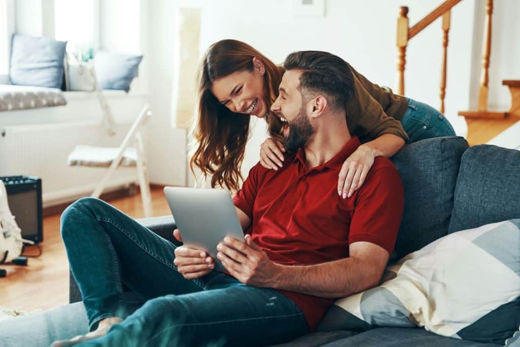 A man and woman looking at the laptop
