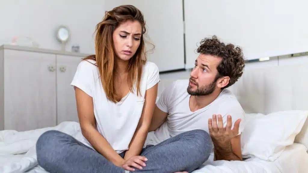 A man talking to her angry wife after a quarrel.