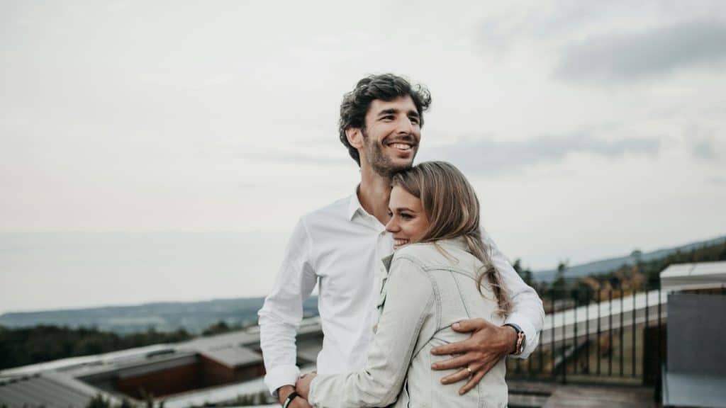 A man and a woman hugging each other.