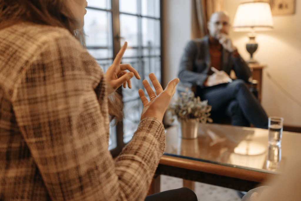 A Woman Explaining to the Man in front of Her