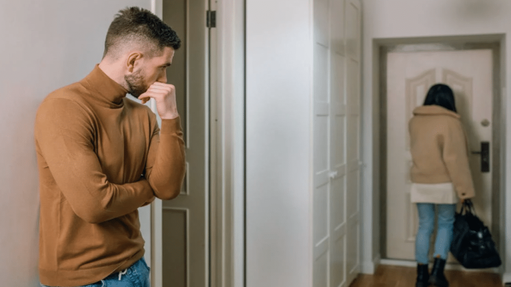 A man watching his wife leave