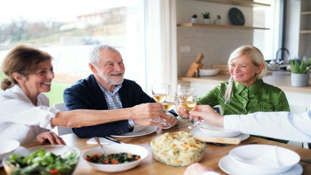 Older people having a meal together