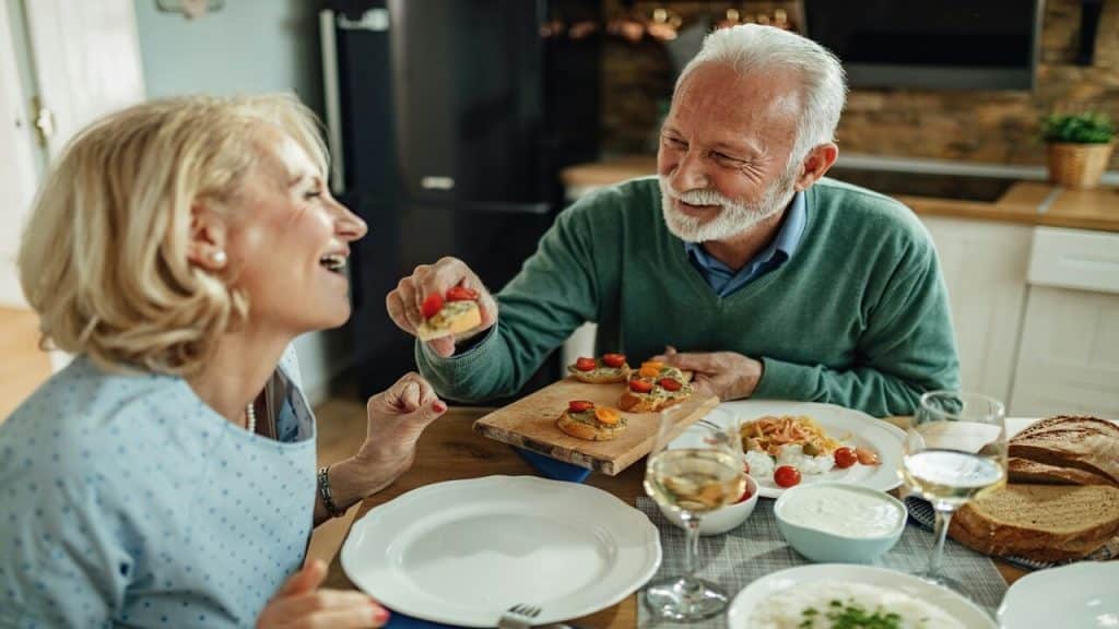 A couple laughing together while eating