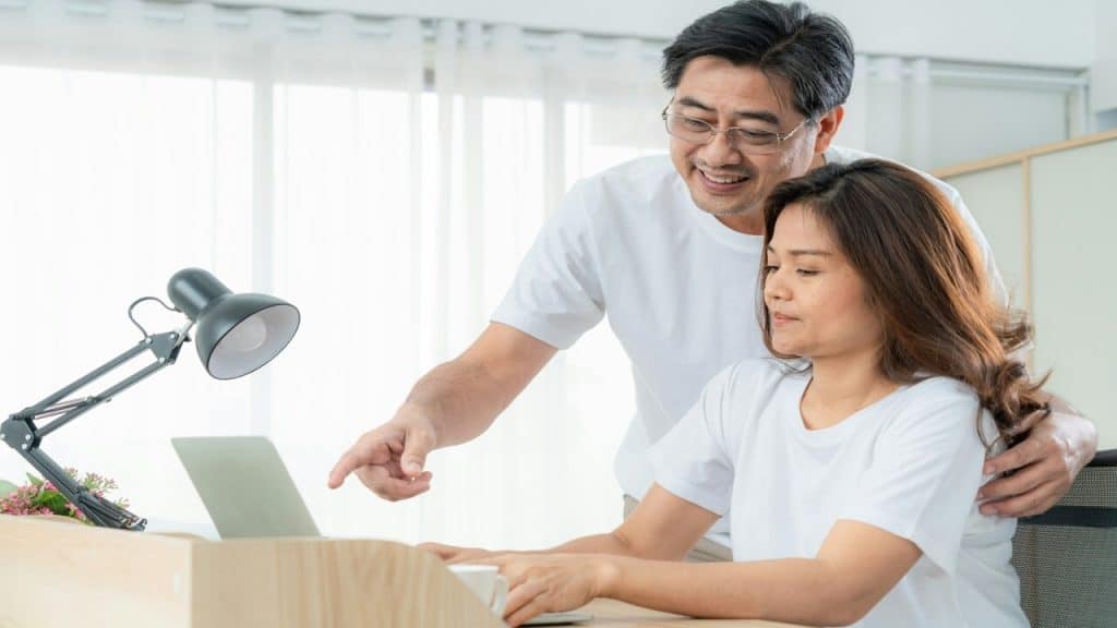 A mature couple using their laptop