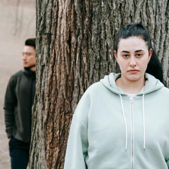 A woman in front and a man behind her