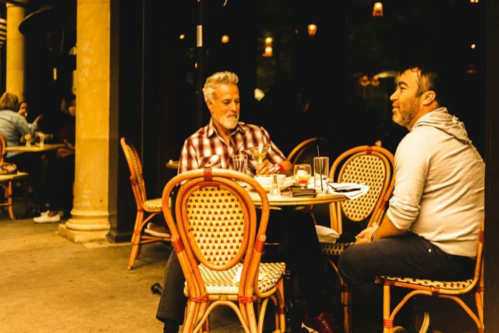 Two men hanging out in a restaurant.