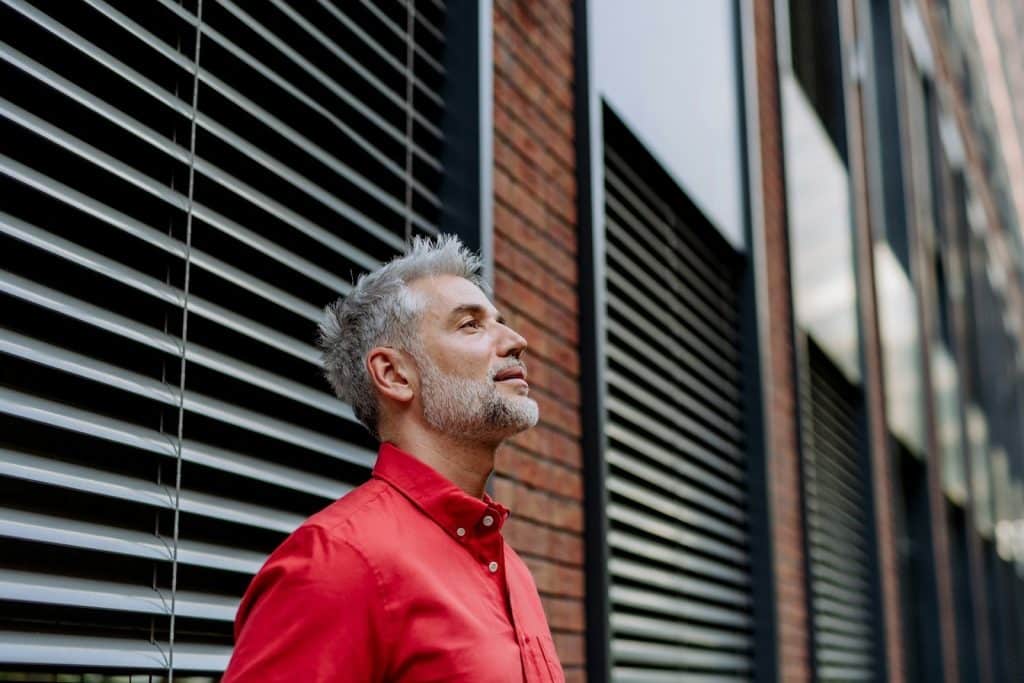 A mature business man standing on the street.