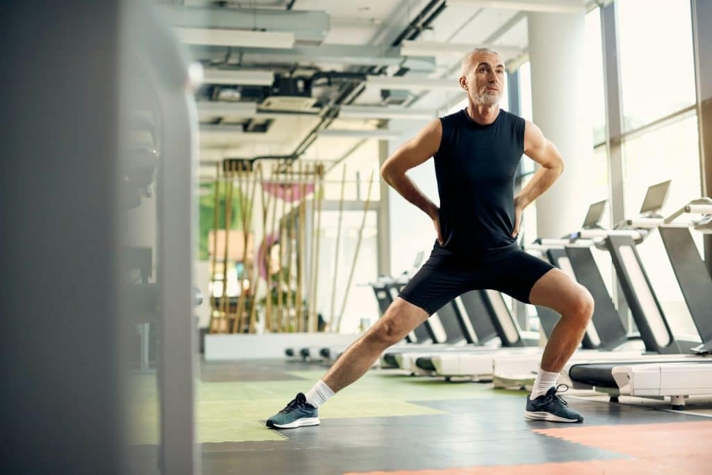 A mature man exercising in a gym.