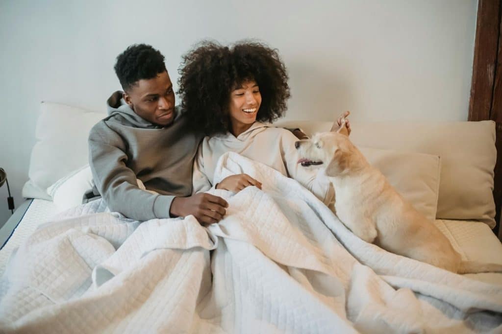 A man and woman resting at the bed