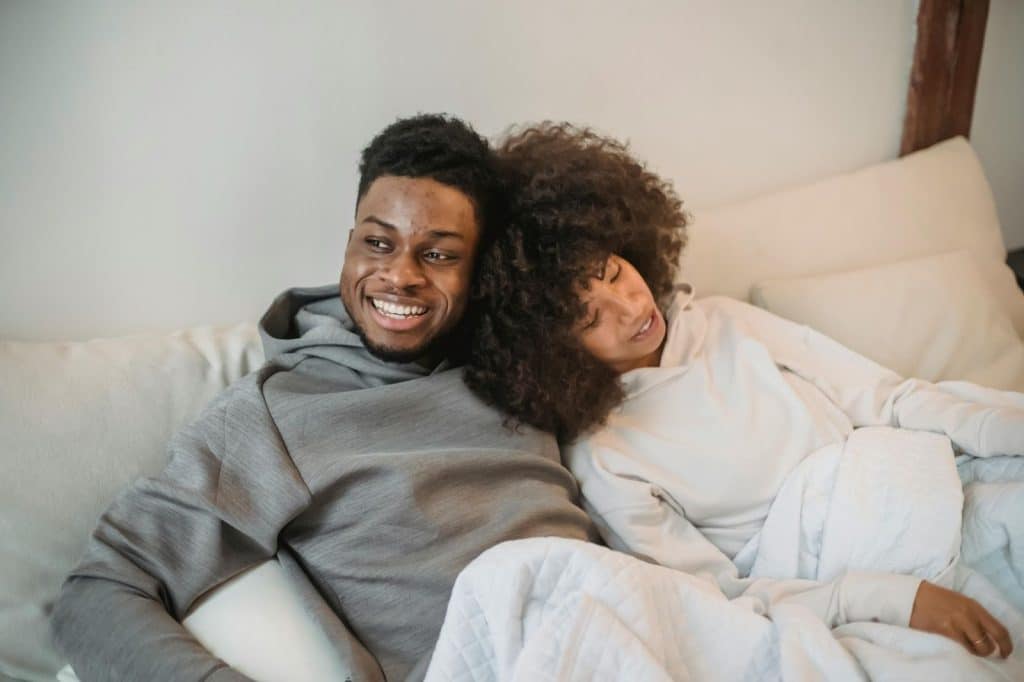 A man and woman at the bed