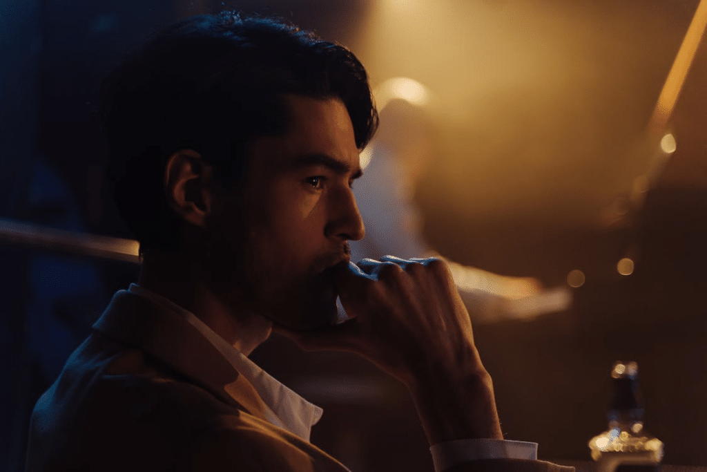 Side View of Man With His Hand on His Mouth