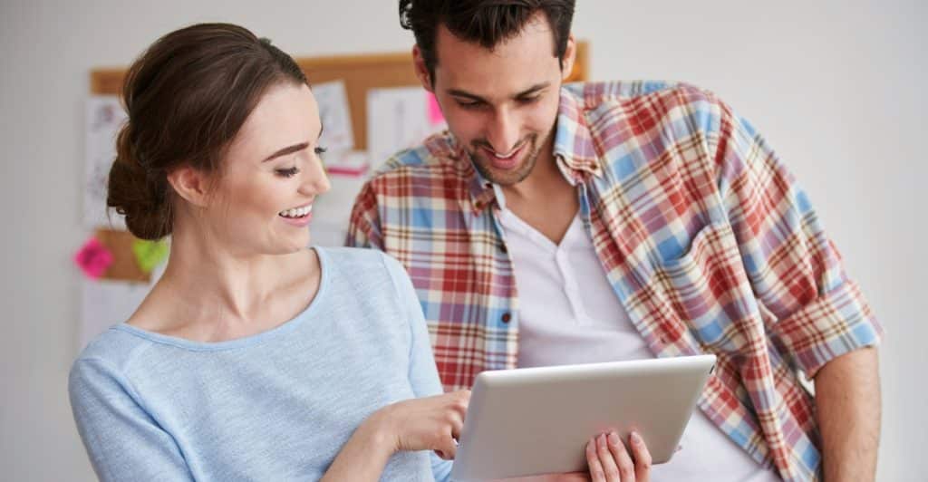 A woman showing something to man