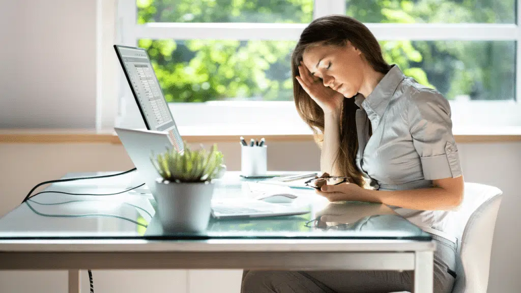 A woman looking tired while working