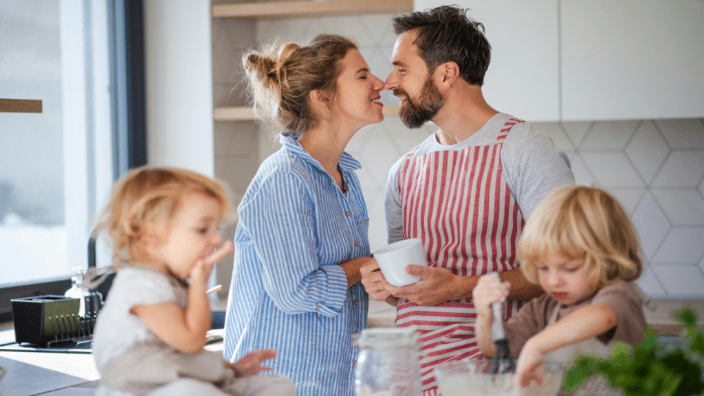 A couple about to kiss in the kitchen