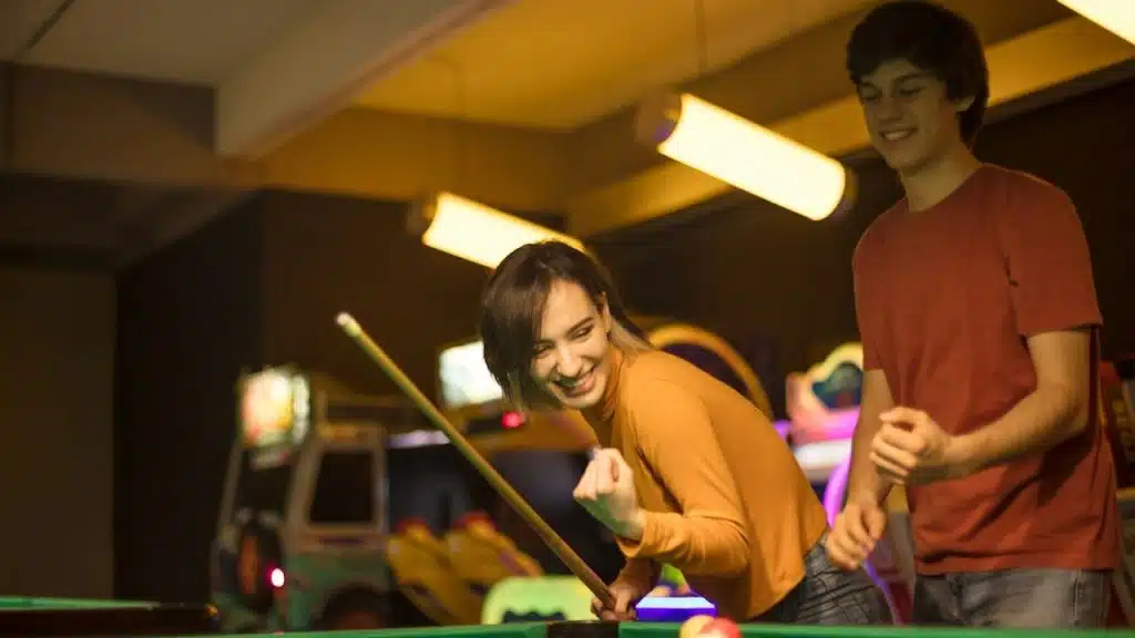 A couple playing pool.
