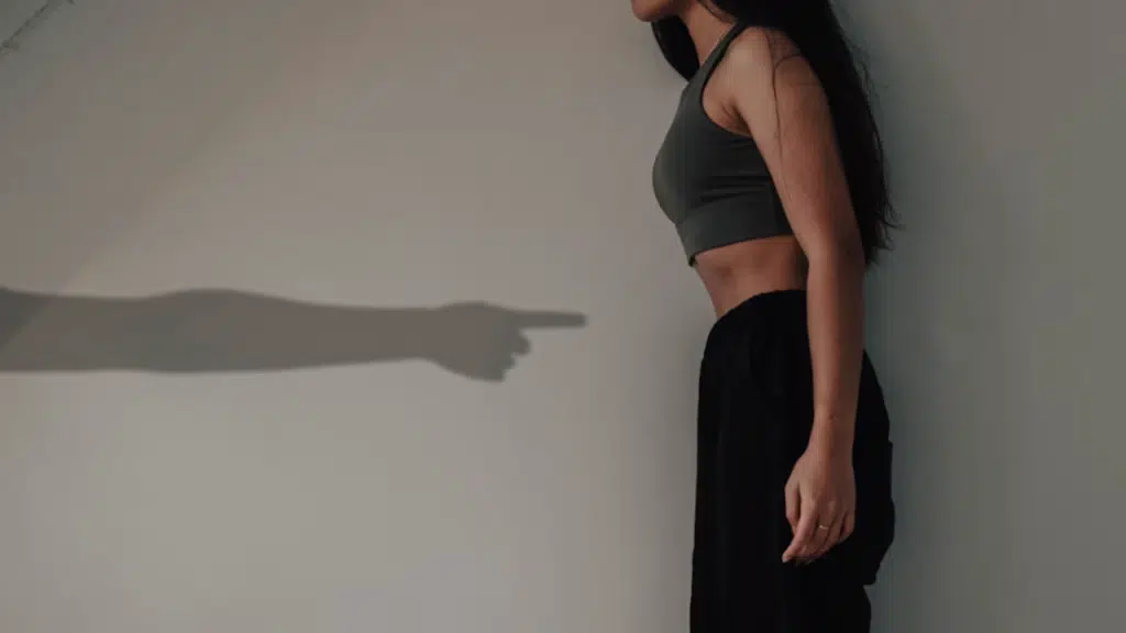 A shadow of a man pointing at a woman
