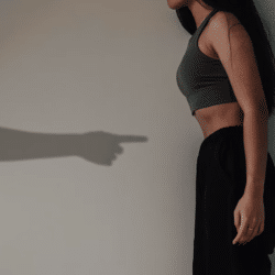 A shadow of a man pointing at a woman