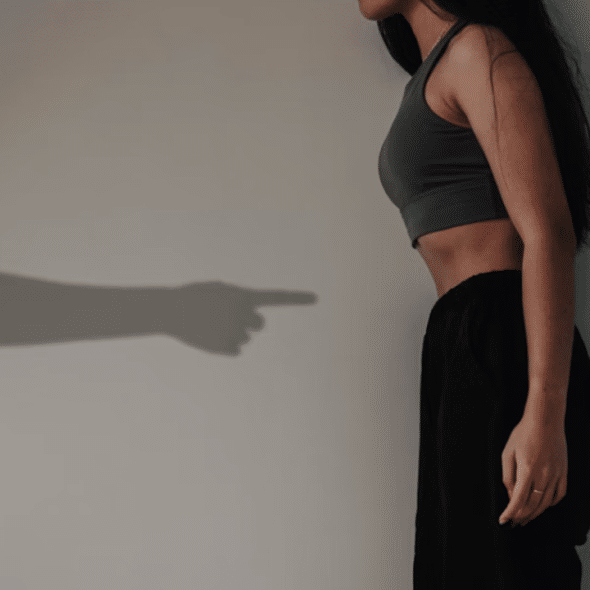 A shadow of a man pointing at a woman