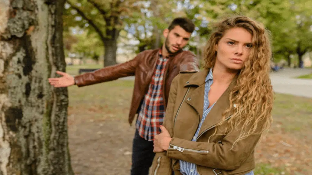 A man apologizing to his wife in a park