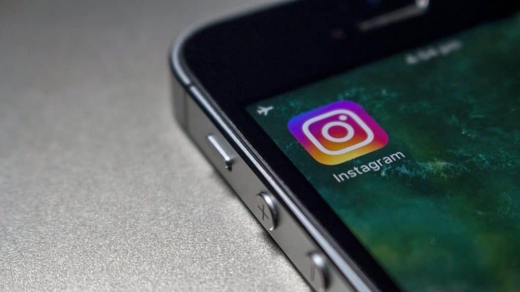 A close-up of a smartphone screen displaying the Instagram app icon and the phone's volume buttons.