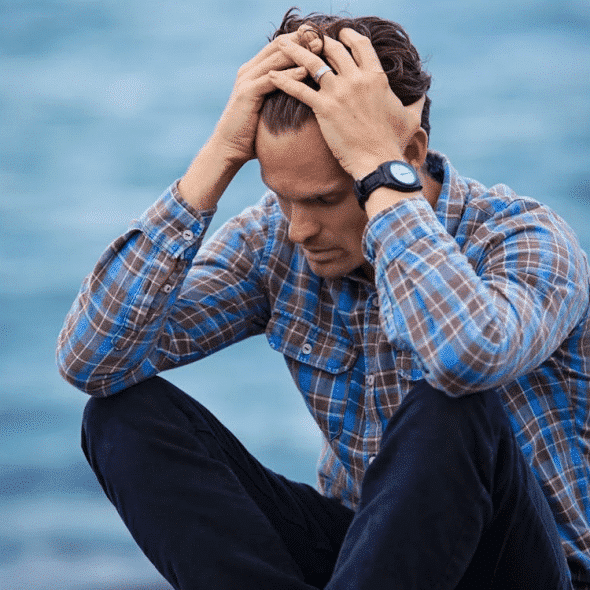 A frustrated man by the sea