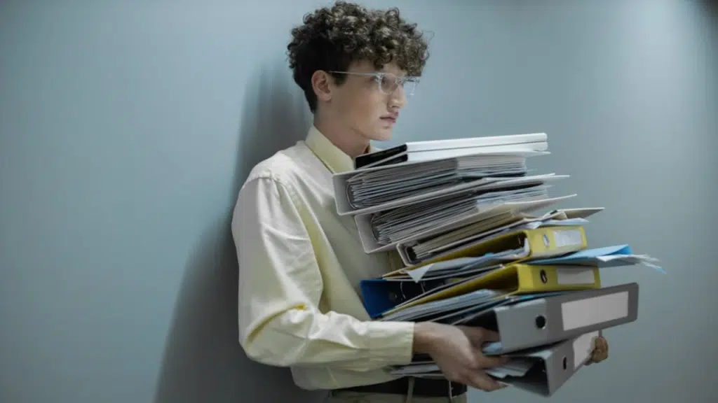 A man carrying a lot of paperwork