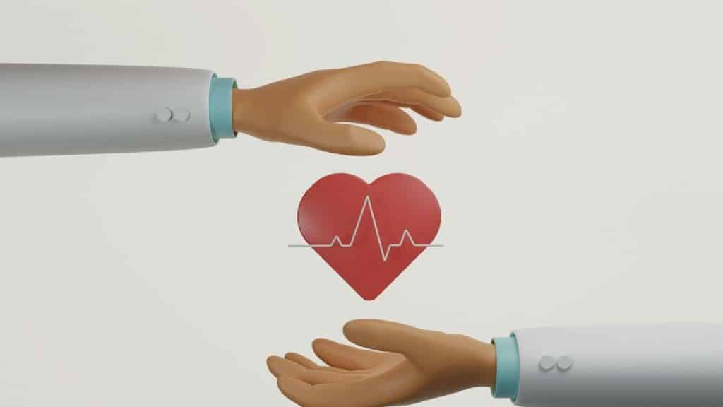 A doctor's hand holding a heart with a lifeline on a white background.