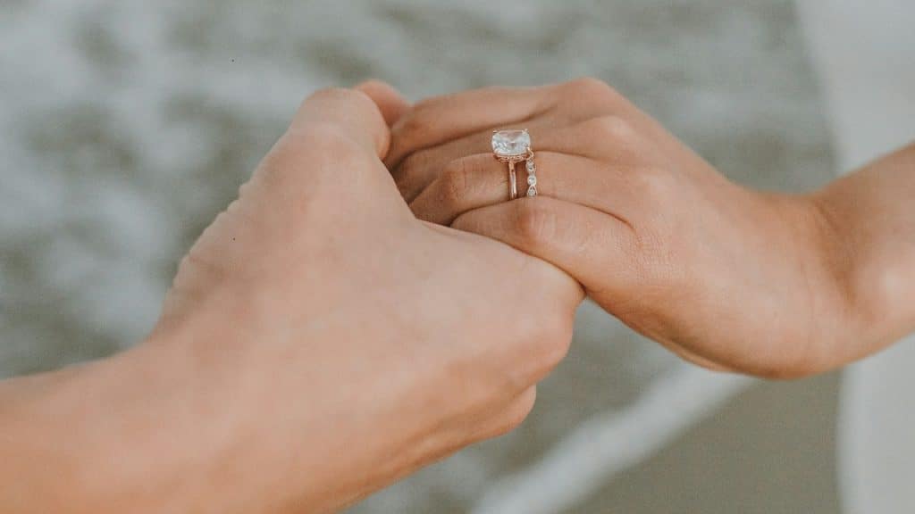 A married couple holding hands.