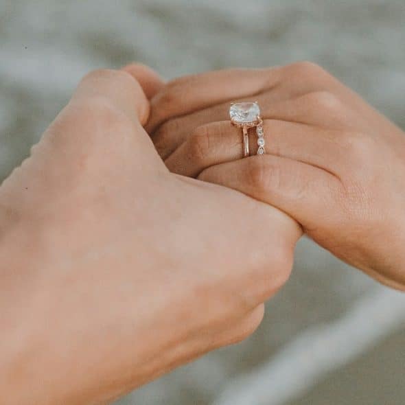 A married couple holding hands.