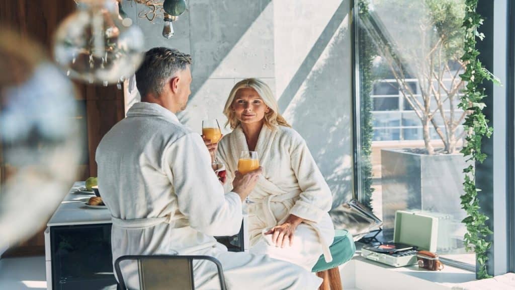 A mature couple talking over mimosas