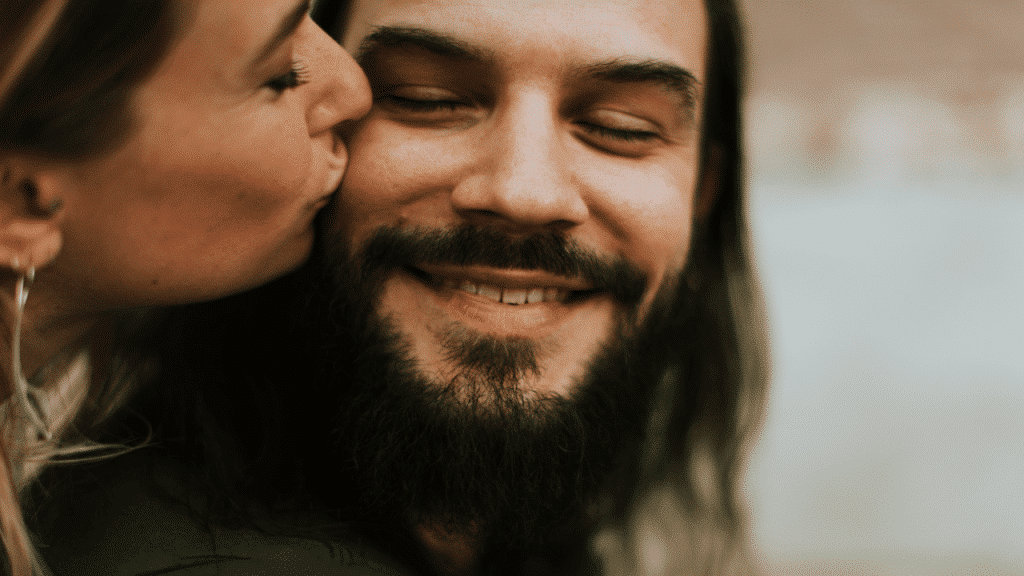 A woman kissing her husband on the cheek