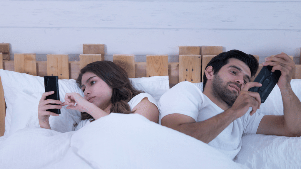 A couple using their phones at night
