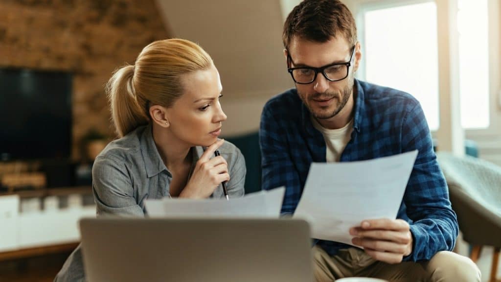 A couple going through their finances while paying bills at home.